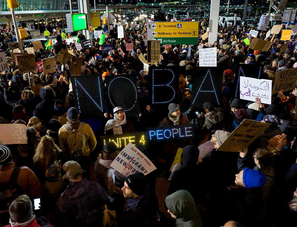 Protesters assemble at John F. Kennedy International Airport in New York, Saturday, Jan. 28, 2017, after earlier in the day two Iraqi refugees were detained while trying to enter the country. AP/PTI