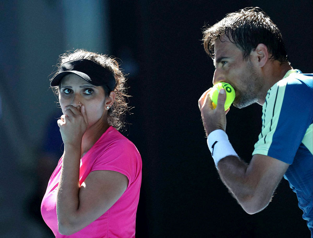 India's Sania Mirza and Ivan Dodig of Croatia talk tactics during their mixed doubles' final against Abigail Speers of the US and Juan Sebastian Cabal of Colombia at the Australian Open tennis championships in Melbourne, Australia, Sunday, Jan. 29, 2017. AP/PTI