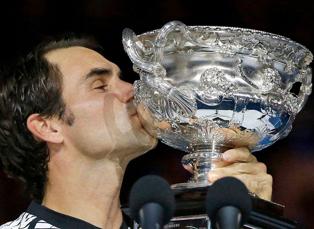 Switzerland's Roger Federer kisses his trophy after defeating Spain's Rafael Nadal in the men's singles final at the Australian Open tennis championships in Melbourne, Australia, Sunday, Jan. 29, 2017. AP/PTI