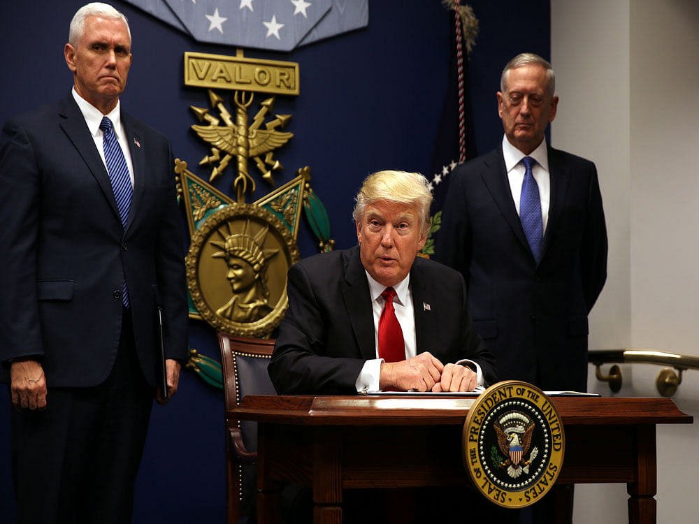 U.S. President Donald Trump signs an executive order to impose tighter vetting of travelers entering the United States, at the Pentagon in Washington. Reuters Photo.