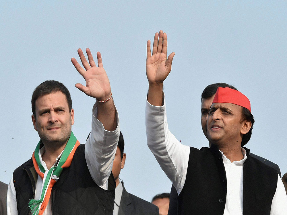 Uttar Pradesh Chief Minister and newly appointed party president Akhilesh Yadav with Congress Vice President Rahul Gandhi at a road show in Lucknow on Sunday. PTI Photo