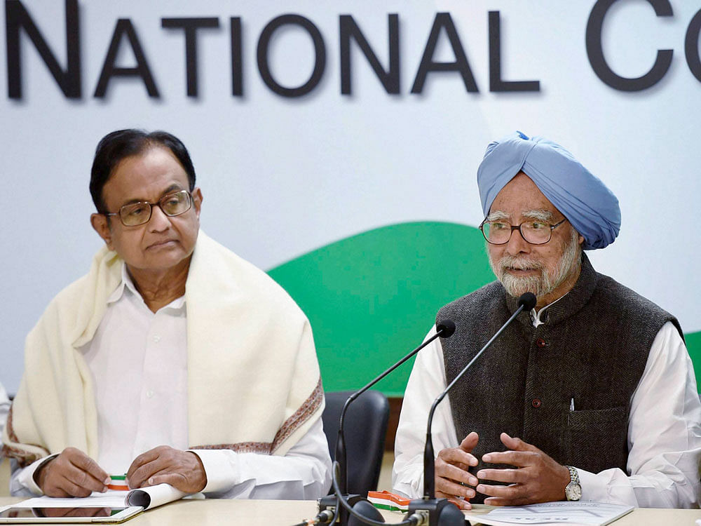 Former Prime Minister Manmohan Singh speaks to media after release 'The REAL State of Economy Report- 2017' at AICC in New Delhi on Monday. Former Finance Minister P Chidambaram is also seen. PTI Photo