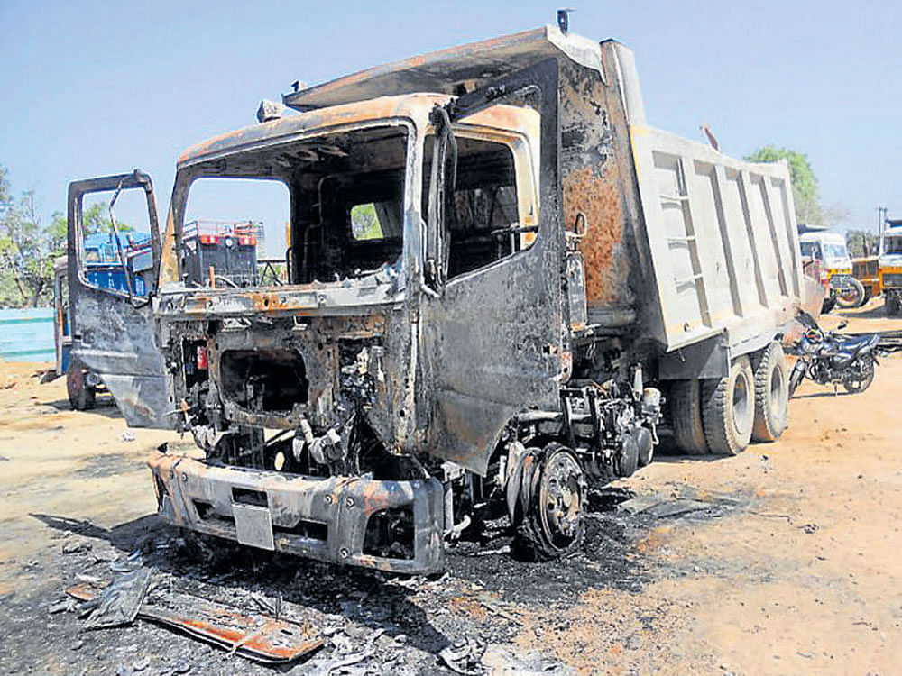 One of the trucks set on fire at Doddabbigere near  Santhebennur in Davangere district. dh photo