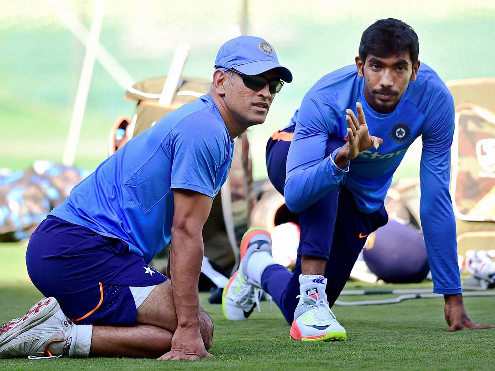 M S Dhoni and Jasprit Bumrah during a practice session ahead of 3rd T20 match against England at Chinnaswamy stadium in Bengaluru on Tuesday. PTI Photo