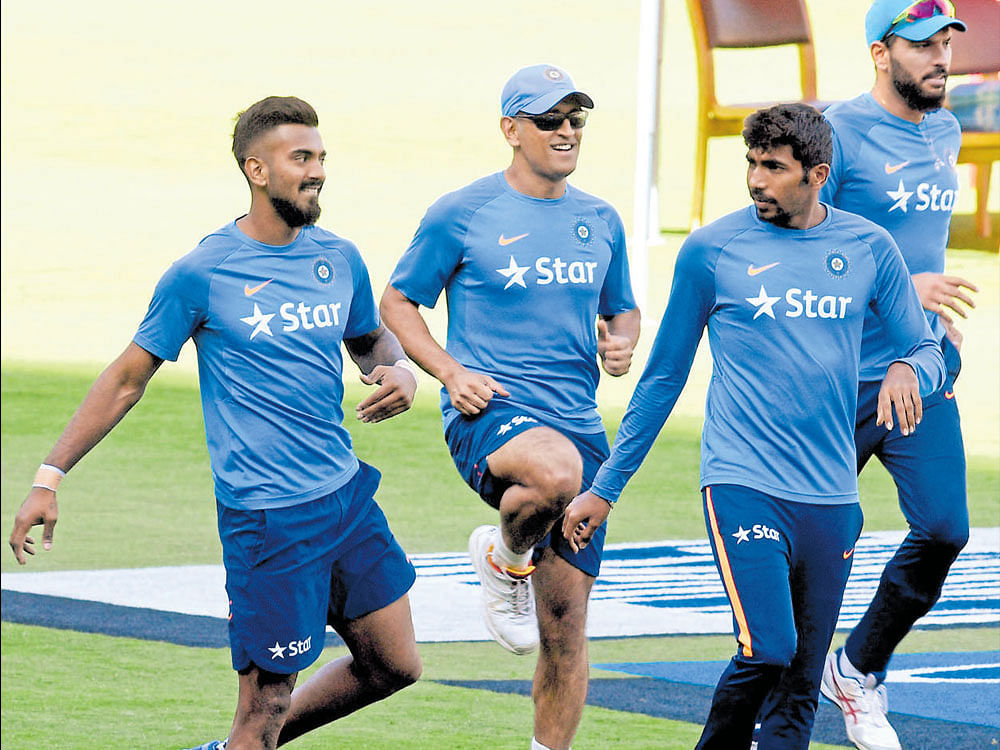 in a relaxed mood: Indian players (from left) KL Rahul, MS Dhoni, Jasprit Bumrah and Yuvraj Singh train during a practice session at the M Chinnaswamy stadium in Bengaluru on Tuesday. dh photo/ srikanta sharma r