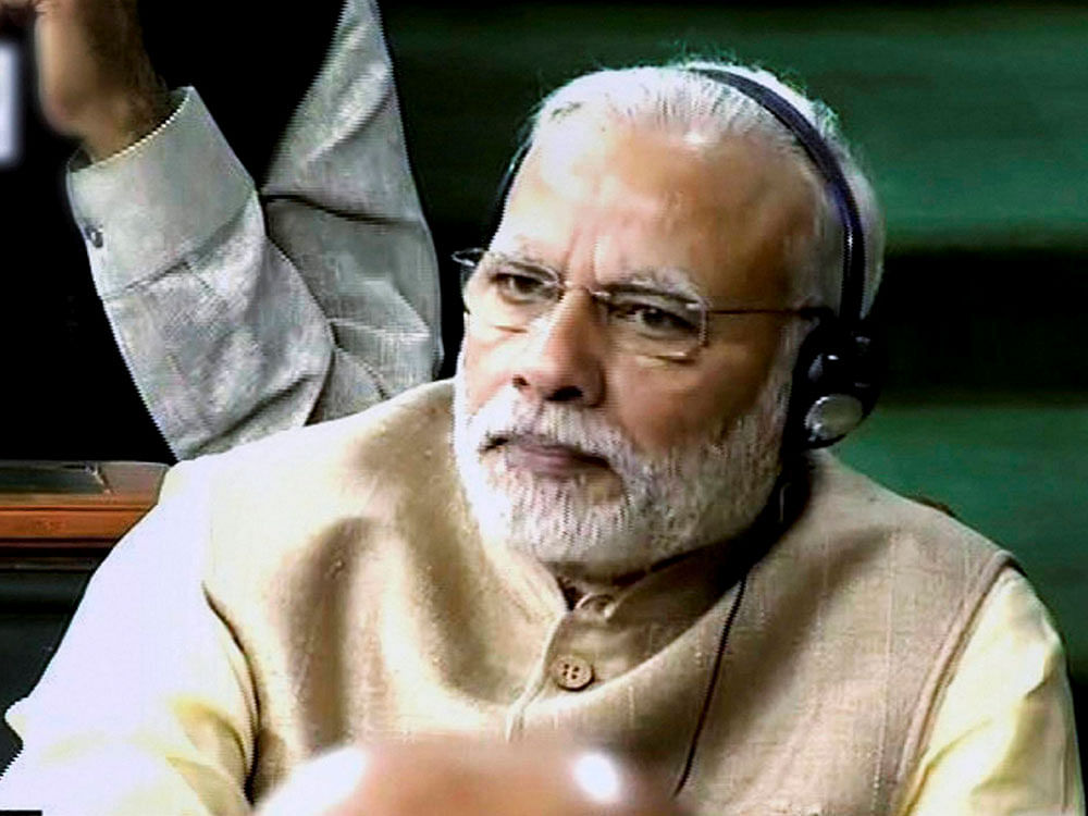 Prime Minister Narendra Modi listening intently as the Union Budget for 2017-18 is tabled in the Parliament in New Delhi on Wednesday. PTI Photo/TV Grab