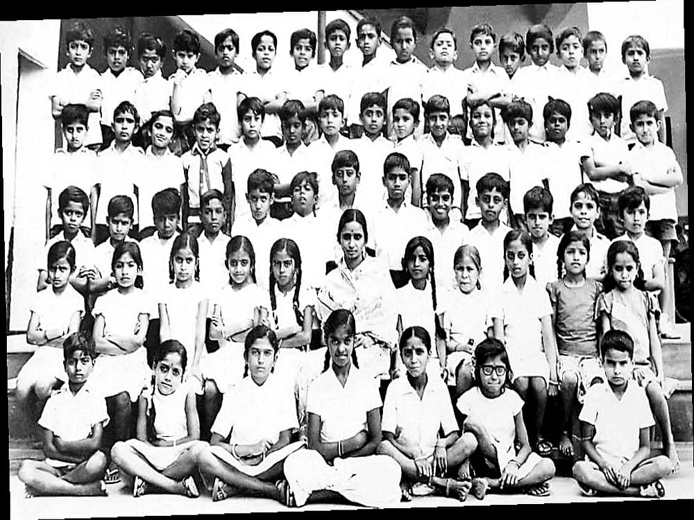 (Sitting on the floor, from left) Veena (second), Jeejabai (third) and Rajalaxmi (fourth). (Sitting on chairs) Malathi (second), Veda (fourth), Teacher KRJ (sixth), Salma (eighth), Sudha (ninth) and Manjula (11th). (Standing, bottom row) Shankara (sixth), S V Manju (seventh) and Abhi (13th). (Standing, middle row) Vikram (third), Vishwanath (fourth) and Prasanna (15th).(Standing, top row) The author (seventh), Bramhadeva (eighth) and Anil (17th).