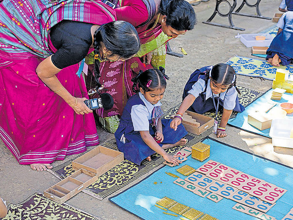 Maths is fun as these children at the BBMP school in Lakkasandra make use of learning kits on Wednesday. dh photo