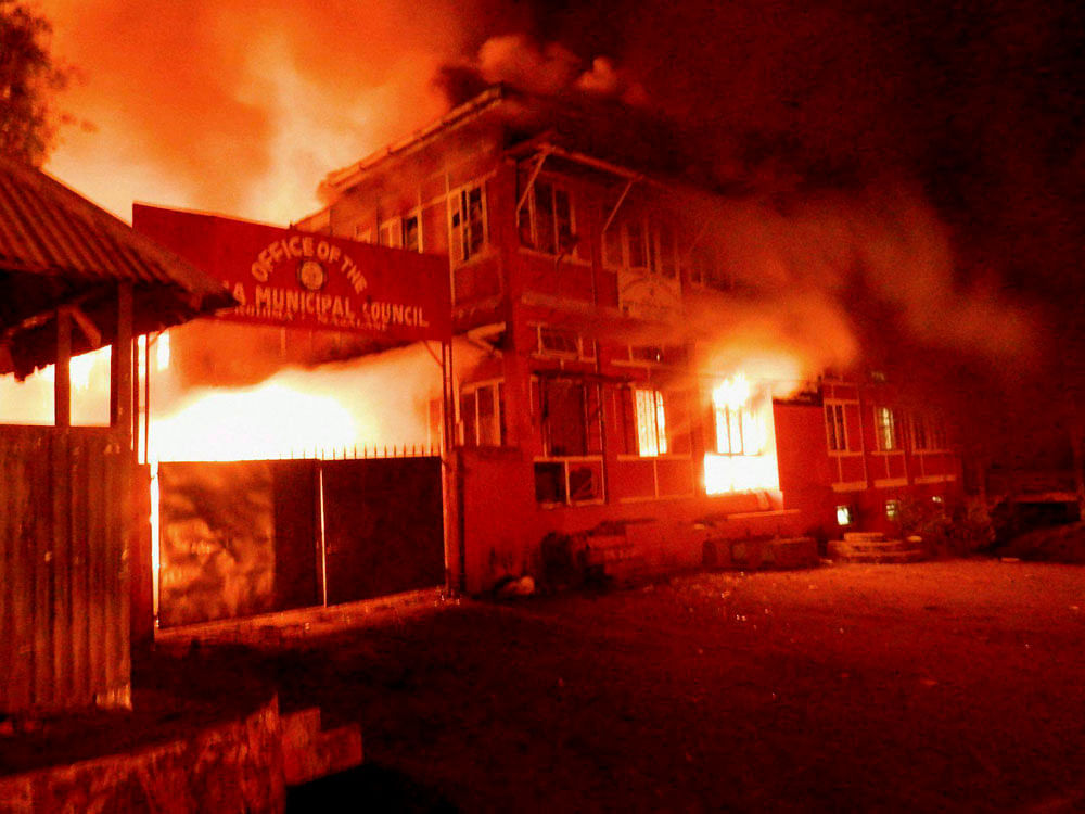 Naga tribals set ablaze the Kohima Municipal Council office and the office of the district collector to protest against Chief Minister TR Zeliang's refusal to meet their ultimatum, in Kohima on Thursday. PTI Photo