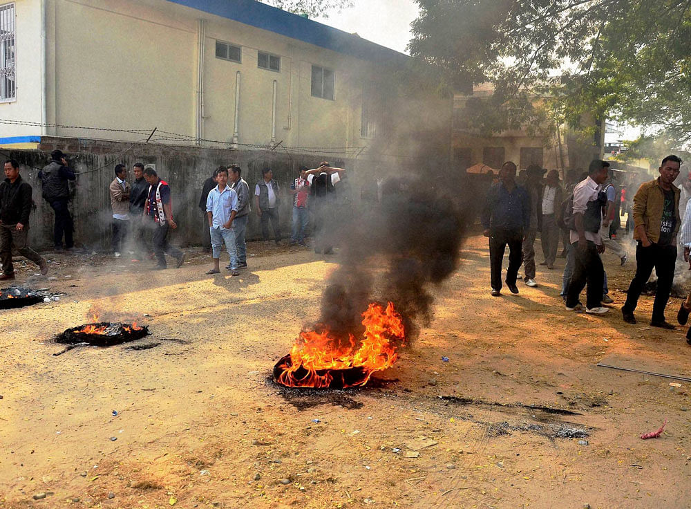 Protesters burn tyres on the road during a bandh called by Joint Coordination Committee against 33 per cent women reservation for the forthcoming Municipal and Urban Local Body election in Dimapur on Saturday.PTI Photo