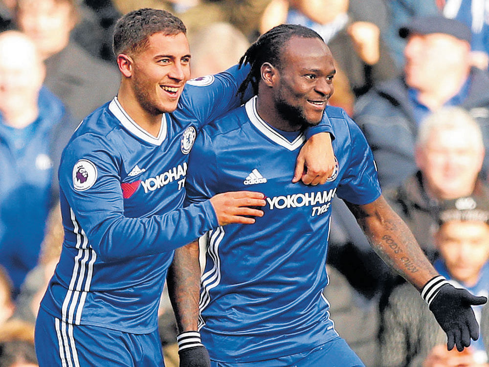 sensational goal: Chelsea's Eden Hazard (left) celebrates with team-mate Victor Moses  after scoring against Arsenal during their EPL clash on Saturday. reuters