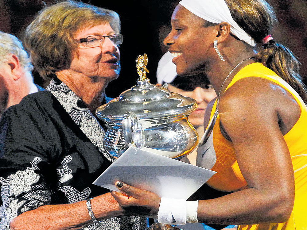 record-holders: Margaret Court hands over the Ausssie Open trophy to Serena Williams in 2010. The American is one win away from equalling Court's all-time record for most Slam wins. reuters