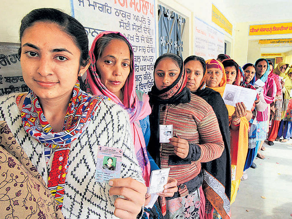 Women voters wait in a long queue at a polling station at Badal village in Muktsar on Saturday. PTI