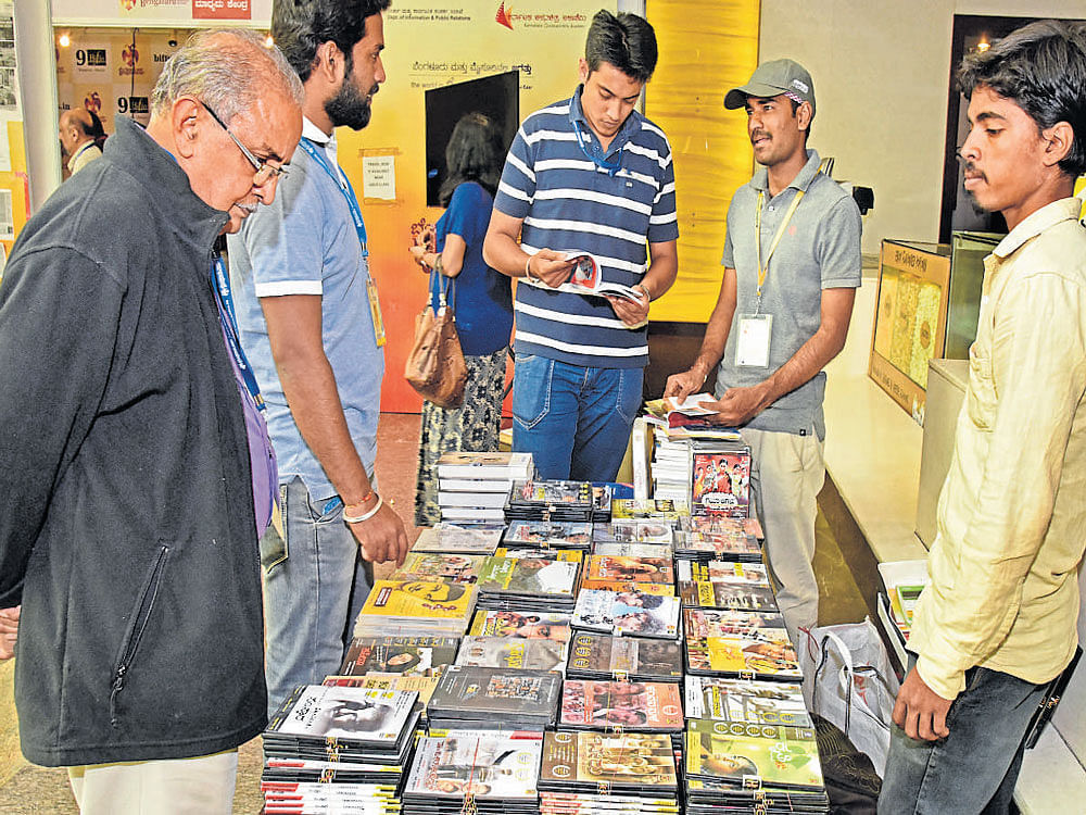 Visitors at a stall selling Kannada film DVDs and books at the Bengaluru International Film Festival at PVR Cinemas, Orion Mall, in Rajajinagar on Saturday. dh Photos