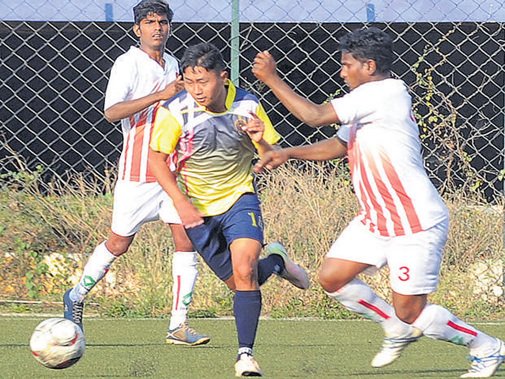 skilful ASC striker Dhawa T Bhutia (centre) tries to evade CIL defender R Vijay in the Super Division. DH photo