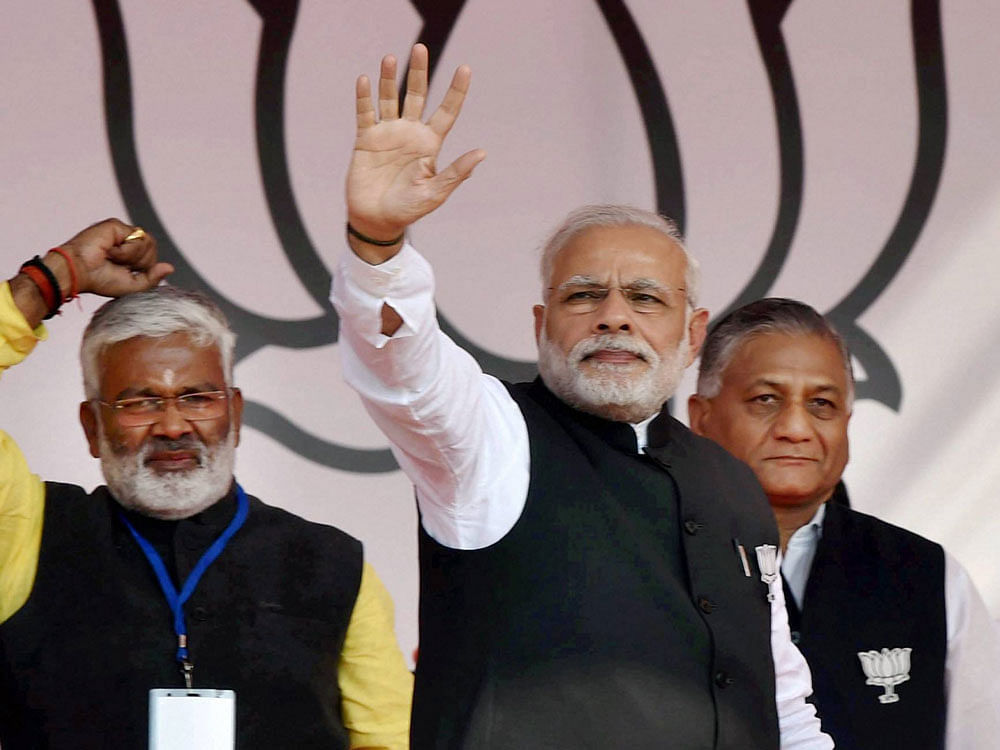 Prime Minister Narendra Modi waves at the crowd during BJP's Parivartan Sankalp Rally in Ghaziabad on Wednesday. PTI Photo