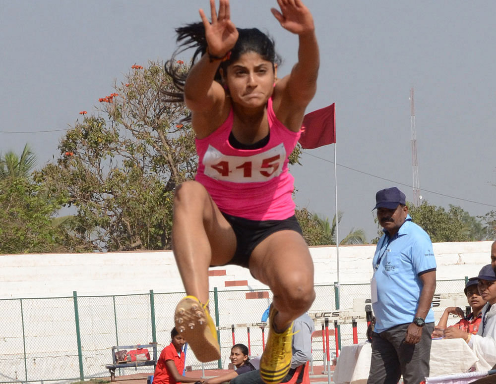 Hop, step and jump: Joyline Lobo of Dakshina Kannada  en route to her gold in triple jump. DH Photo/ Kedarnath