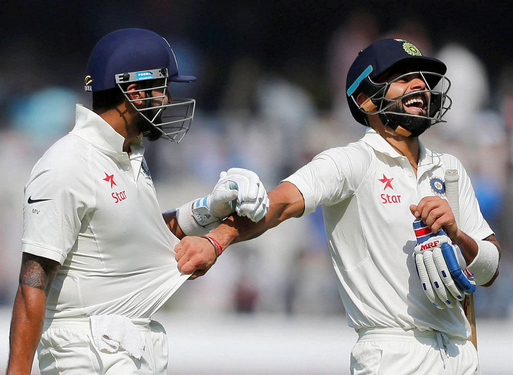 Centurions: Virat Kohli and Murali Vijay celebrate after reaching their hundreds on the opening day of the one-off Test against Bangladesh in Hyderabad on Thursday. India were 356 for three at close. AFP