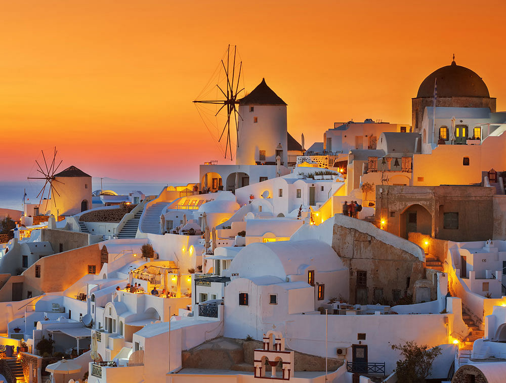 Natural masterpiece: During sunset, the village of Oia is painted in orange. Visitors throng the spot to witness this splendorous, if only everyday, view.