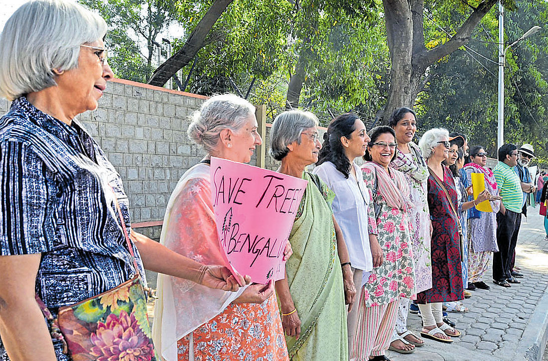 People form a human chain on Saturday to protest felling of trees on Jayamahal Road. dh photo