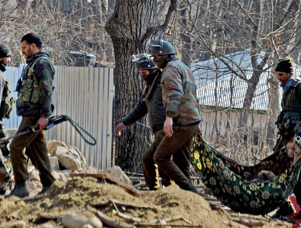 Special Operation Group (SOG) of Jammu and Kashmir police carrying the body of a militant which was recovered from the rubbles of destroyed house where militants were hiding during an encounter at Frisal area of Kulgam district of South Kashmir on Sunday. PTI Photo
