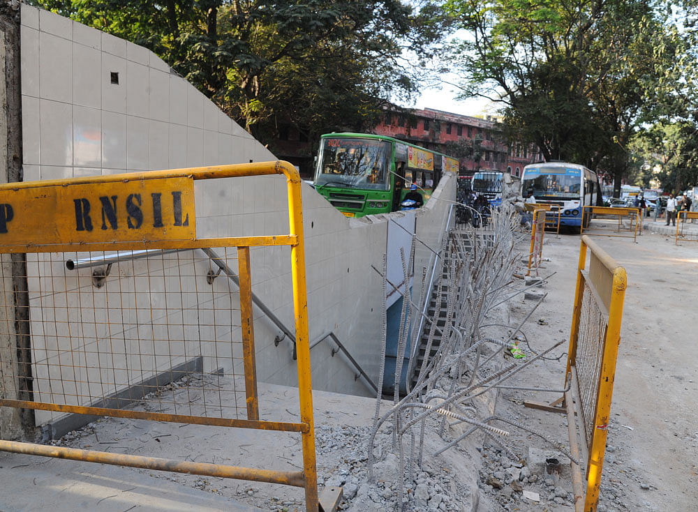 A portion of the wall at the entrance of the subway on Nrupathunga Road was demolished on Monday. DH photo