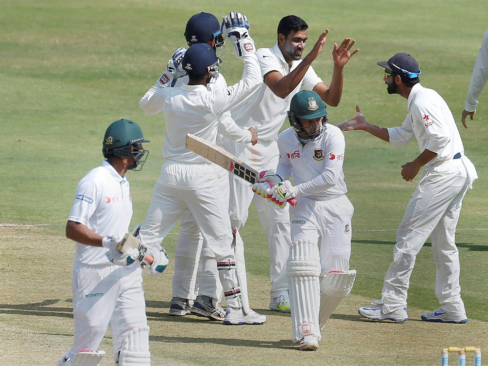 India's Ravichandran Ashwin celebrates with teammates the dismissal of Bangladesh's captain Mushfiqur Rahim during the last day of their one-off cricket test match in Hyderabad on Monday. PTI Photo
