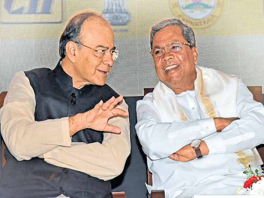Finance Minister Arun Jaitley interacts with Karnataka            Chief Minister Siddaramaiah at the inaugural session of  Make in India- Karnataka Conference in Bengaluru on Monday. DH photo by S K Dinesh