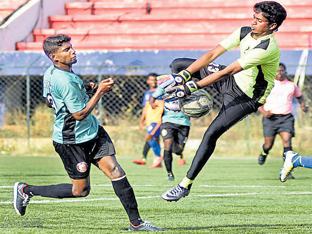 So close South United's Senthil (left) tries to score past the DYES goalkeeper Bheem Shankar during their BDFA&#8200; Super Division Football league tie on Tuesday. DH&#8200;Photo