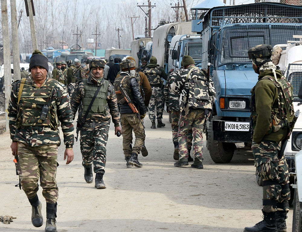 Security personnel leaving after the end of encounter with militants at Hajan of district Bandipora of North Kashmir on Tuesday. Three army men one militant and fifteen others were injured in gun battle. PTI Photo
