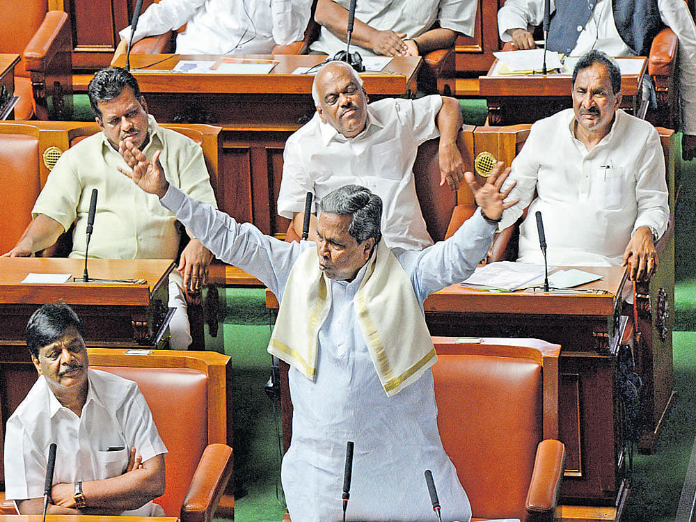 Chief Minister Siddaramaiah speaks during the Assembly session on Monday. Ministers  H C Mahadevappa, K R&#8200;Ramesh Kumar and K J George are also seen. dh photo