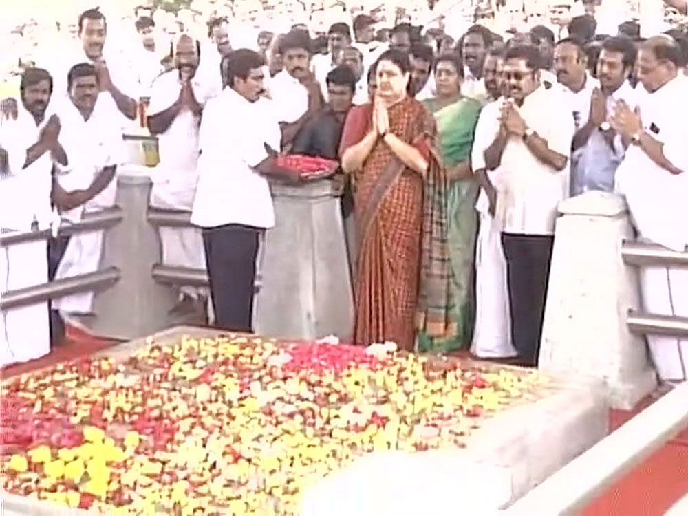 At the Jayalalithaa memorial on the Marina Beach, Sasikala paid floral tributes and was seen muttering something which was not audible. She had yesterday given pep talk to MLAs and supporters to stay bold and remain united. Image: ANI Twitter