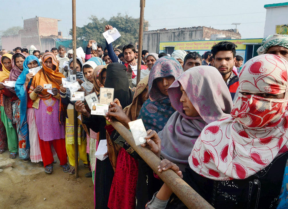 Voters are in queue to cast their vote at a polling station during the second phase of up assembly election in Gajraula on Wednesday .PTI Photo