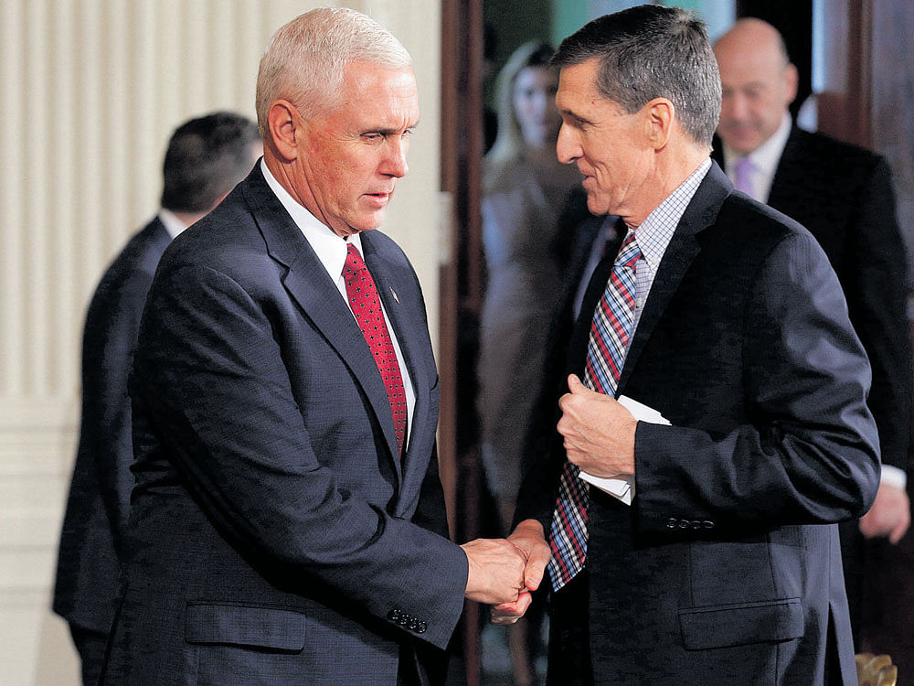 a shake-up: US vice president Mike Pence greets then National Security Adviser Michael Flynn. The White House says that Pence had been misled by Flynn when he went on air to defend the Trump administration's NSA pick over calls made to the Russian ambassador. REUTERS