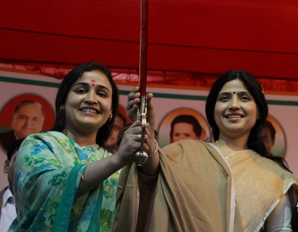 Samajwadi Party MP Dimple Yadav (right) and party candidate Aparna Yadav at a rally in Lucknow on Wednesday. PTI