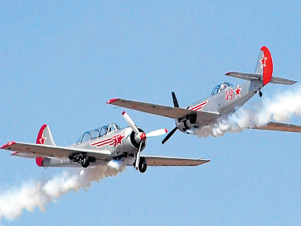 Yakovlevs aerobatic teams perform at Yelahanka Air Force Station in Bengaluru on Thursday. DH photos by B K Janardhan & Kishor Kumar Bolar