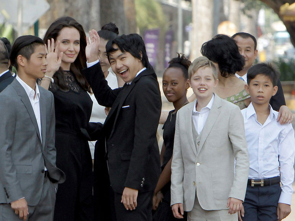 Hollywood actress Angelina Jolie, second from left, waves with her adopted children Pax, left, Maddox, center, Zahara, third from right, and Shiloh, second from right, while they wait to meet Cambodia's King Norodom Sihamoni in Siem Reap province, Cambodia, Saturday, Feb. 18, 2017. Jolie on Saturday launches her two-day film screening of 'First They Killed My Father' in the Angkor complex in Siem Reap province. AP/PTI Photo