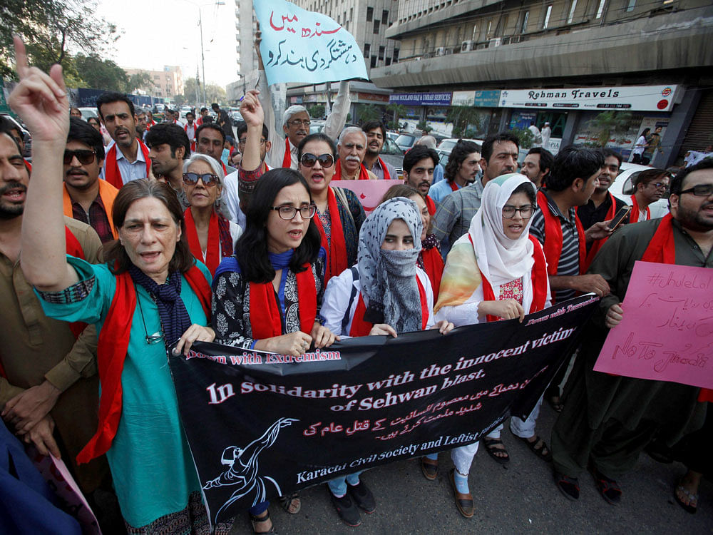 Pakistani civil society activists protest a recent series of suicide bombings that killed dozens of people, in Karachi, Pakistan, Saturday, Feb. 18, 2017. Pakistani authorities shut down a second key border crossing into Afghanistan, halting trade supplies to the neighboring landlocked country and increasing tensions between the two nations in the wake of a bloody suicide bombing at a beloved shrine in Pakistan, officials said Saturday. Placard at top reads, 'stop terrorism in Sindh province.' AP/PTI Photo