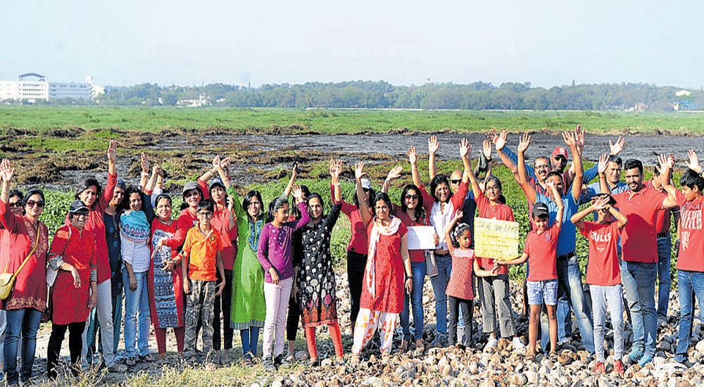 Residents of Bellandur and nearby areas protest in front of the Bellandur Lake on Saturday. dh photo