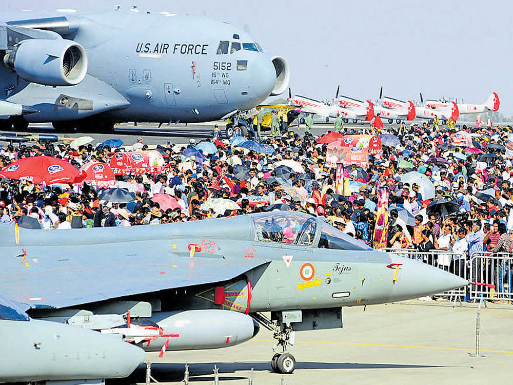 The crowd soaks in the majestic feel of the metal birds on the last day of Aero India on Saturday. DH Photo.