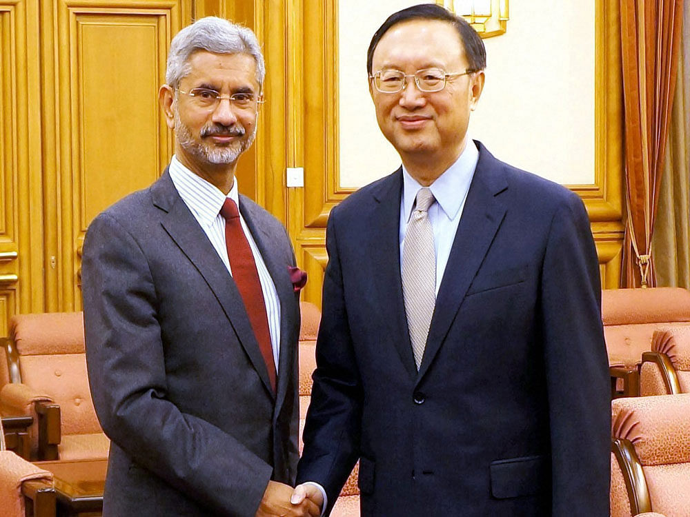 Foreign Secretary S Jaishankar shakas hands with top Chinese State Councillor Yang Jiechi in Beijing on Tuesday ahead of India-China strategic Dialogue on Wednesday. PTI Photo