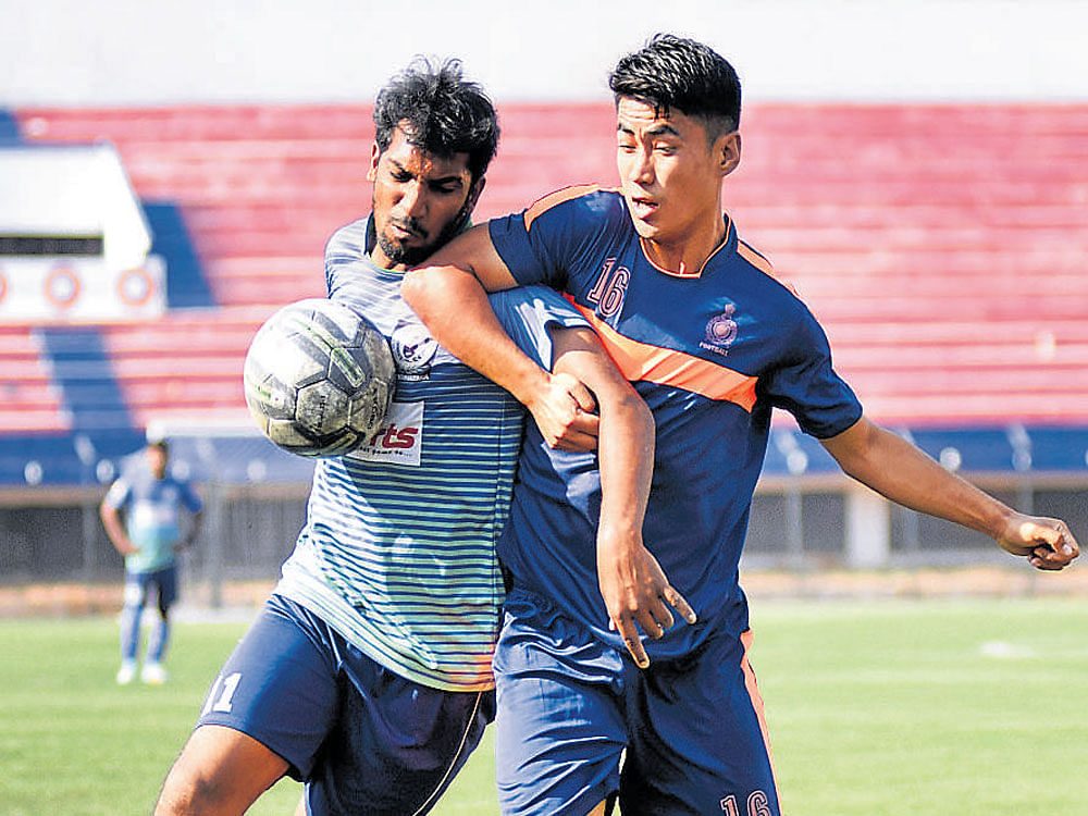 INTENSE DUEL AGORC's Dada Nabeel (left) and ASC's Diwakar vie for the ball during their Super Division game. DH Photo