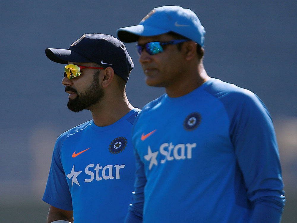 India's captain Virat Kohli and team coach Anil Kumble attend a practice session ahead of their first test cricket match. Reuters Photo.