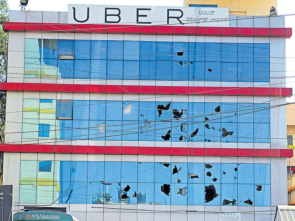 Windowpanes of Uber's corporate office at HSR Layout,  damaged in stone throwing  on Wednesday. DH photo