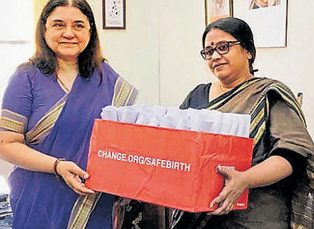 Maneka Gandhi receives a petition from crusader Subarna Ghosh in New Delhi on Wednesday. PTI