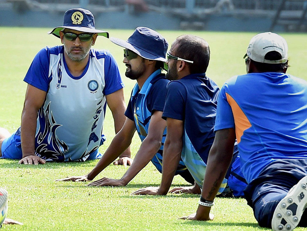 Jharkhand Captain M S Dhoni with his teammates during a training session at Eden Garden in Kolkata on Thursday as a part of preparation for Vijay Hazare Trophy. PTI Photo