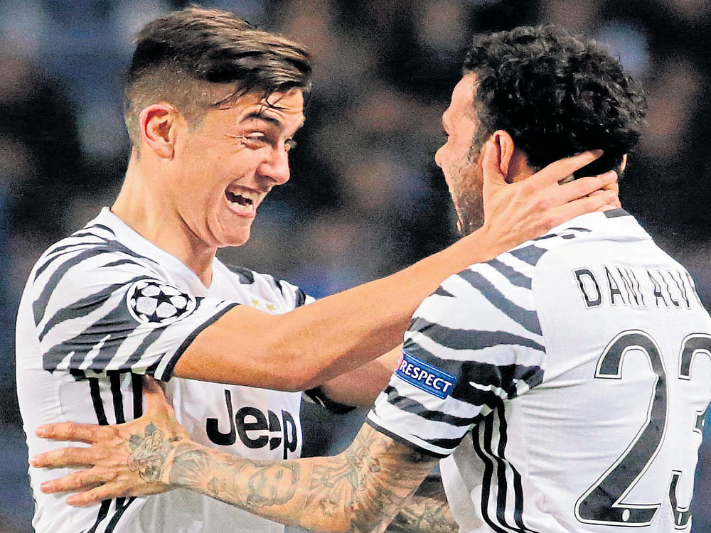 that's special, mate: Juventus' Paulo Dybala (left) congratulates Dani Alves for his goal in their Champions League game against Porto in Lisbon on Wednesday. Juventus won the match 2-0. AFP