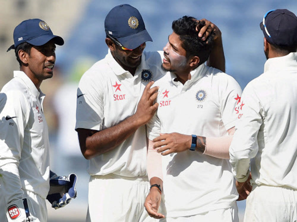 Indian bowler Umesh Yadav celebrates with teammates the wicket of Australian batsman Nathan Lyon during the first day of the first cricket test match in Pune on Thursday. PTI Photo