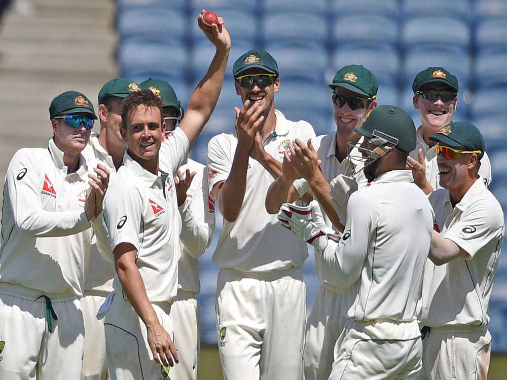 Australian bowler Steve O'Keefe celebrates his six wickets during the first test match played against India in Pune on Friday. PTI Photo