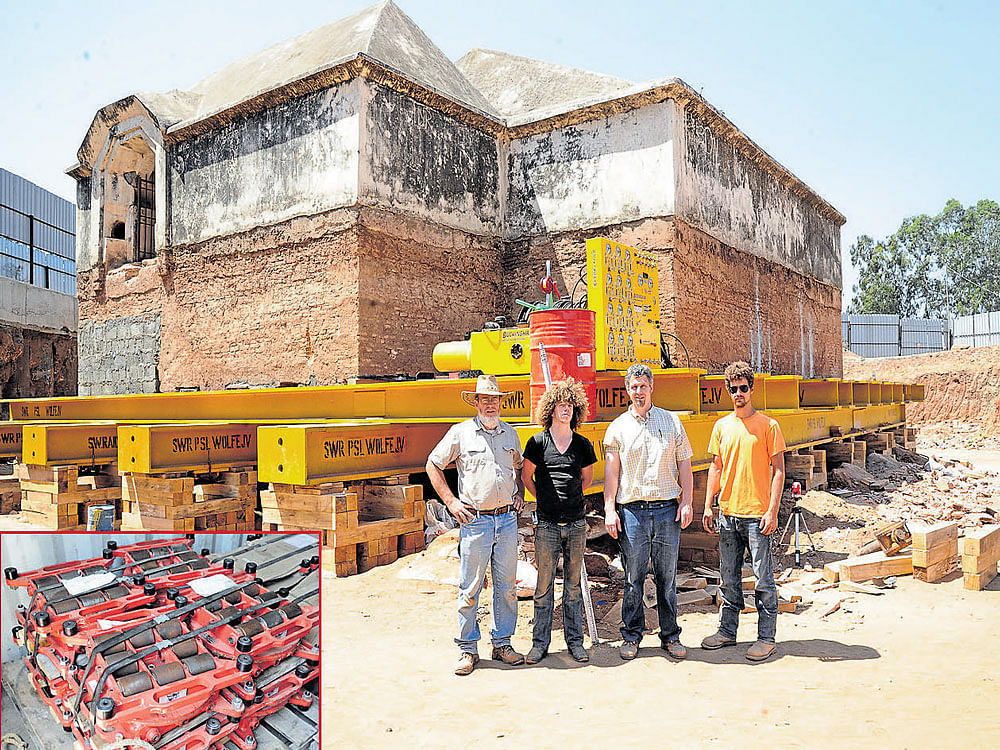 The members of Wolfe House Movers (from left to right) Jeffery Brovont, Jamin Puckingham, Philip Hansen and Peter Hansen working to shift the Tippu armoury to make way for track doubling work at Srirangapatna in Mandya district on Friday. (inset) The rollers used to shift the armoury. These 25-tonne and 50-tonne rollers were shipped in containers from Pennsylvania, United States. DH Photo/Srikanta Sharma R